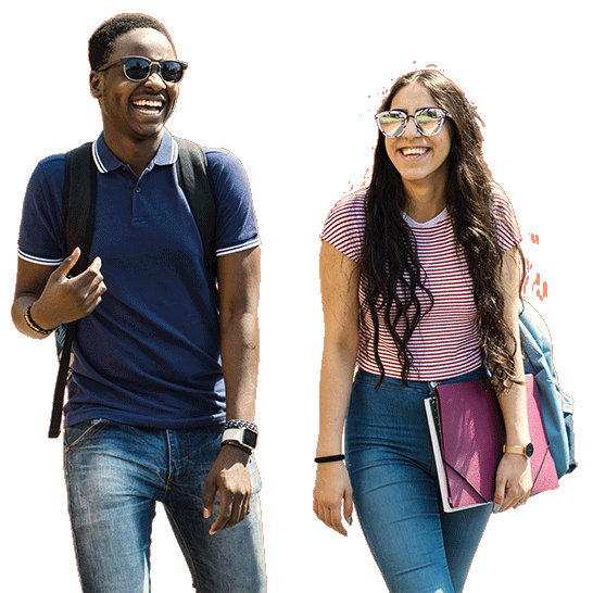 Two students walking along together and laughing.