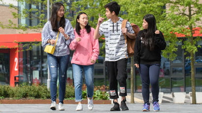 Group of students walking on Frenchay Campus.