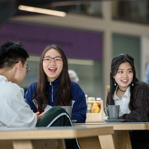 International students sat around a table, laughing.