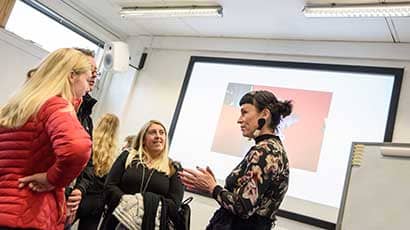 A member of staff talking to Offer Holder Day attendees.