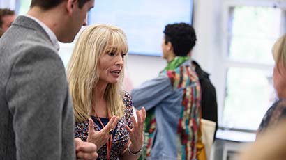 An academic speaking to a prospective student at an Open Afternoon