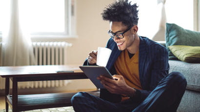 Person at home using a tablet.