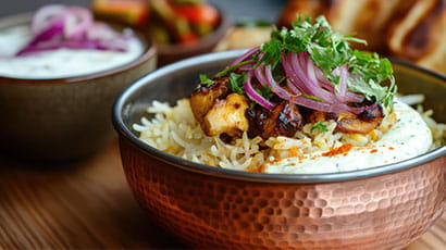 A side on close up of an indian dish in a copper bowl.