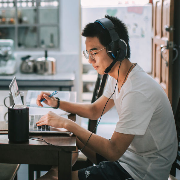 Person using a laptop in their kitchen.