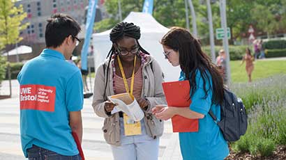 Two student ambassadors helping an Open Day attendee.