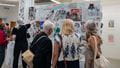 Visitors looking closely at art work on display at Bower Ashton Campus during Open Day.