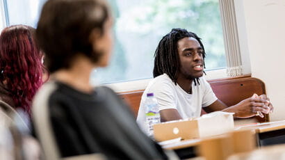 Philosophy students working together smiling