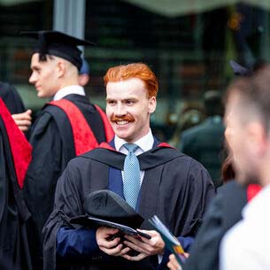 Gowned student graduating at Bristol Beacon