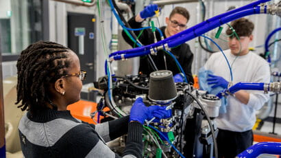 Students displaying equipment and the facilities in the Engineering Building.