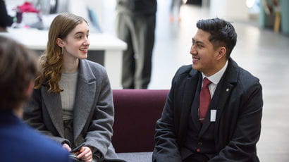 Smartly dressed people sat in a lobby area.