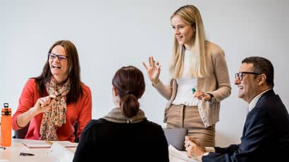 A group of mature students talking together at a workshop.