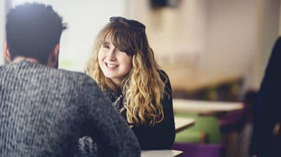 A female student listening to her peer