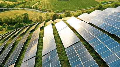 Solar panels on the side of a hill.