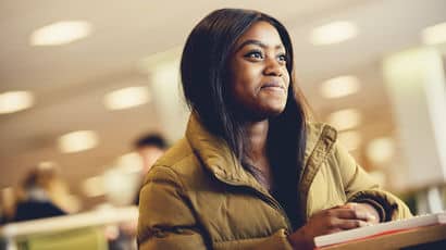 Student smiling and gazing into the distance