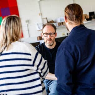 Academic talking to a couple of people