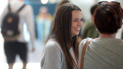 Girl smiling at a women