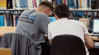 Two students studying in Frenchay Library.