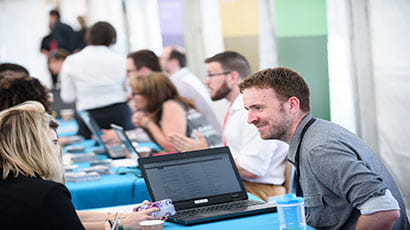 A student talking to an adviser at an open event