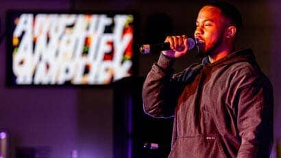 Performer on stage holding a microphone