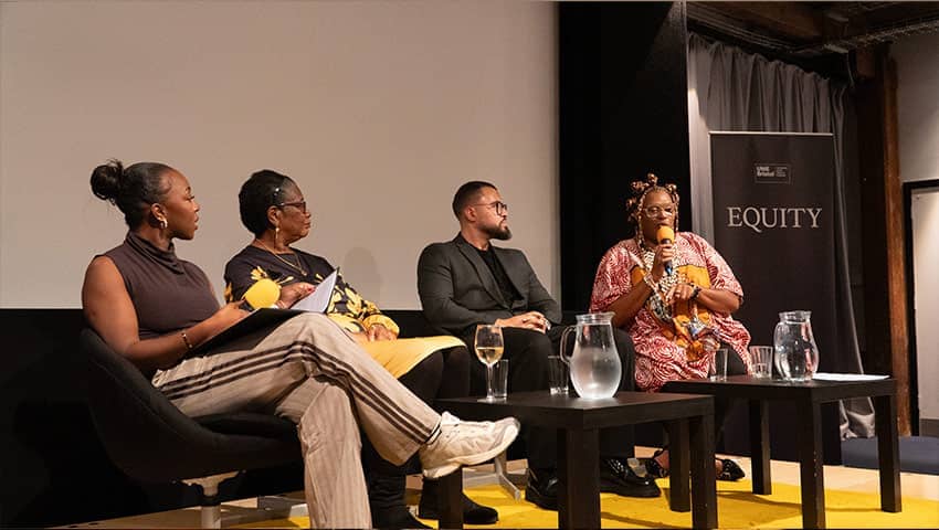 Four speakers on stage during the BDAS event.