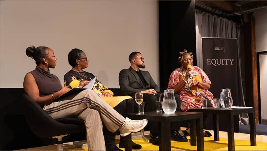 Four speakers on stage during the BDAS event.