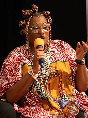 Speaker, Mo Ebengho, talking into a microphone at the BDAS event.