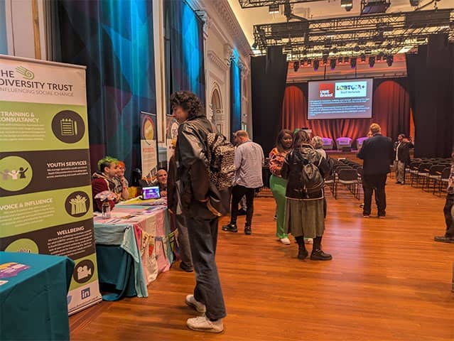 People networking and visiting information stalls at the ‘From Evolution to Activism’ BDAS talk.