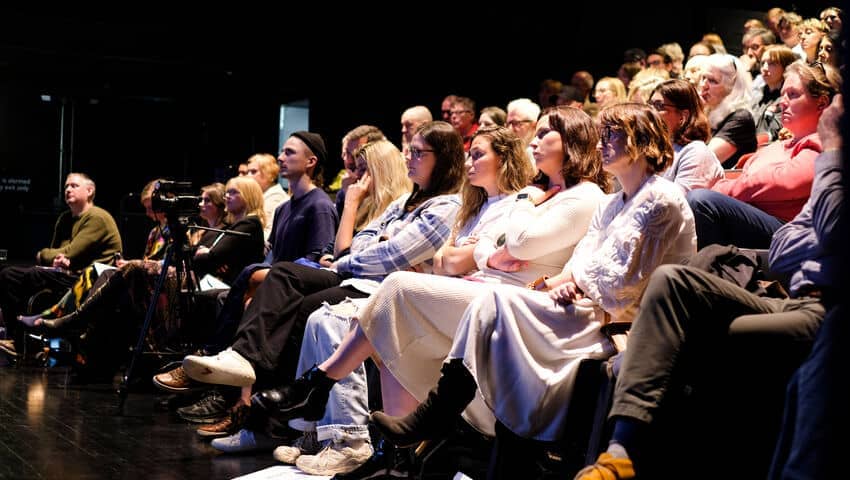 An audience in an auditorium.