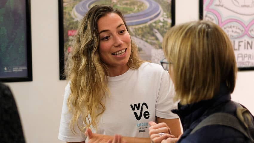 Two women talking, one with a WAVE T-shirt on.