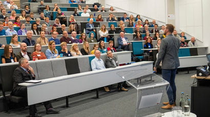 Person giving a Bristol Distinguished Address talk to a crowd.