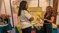 A stall holder talking to a guest after the BDAS Waste to Worth event.