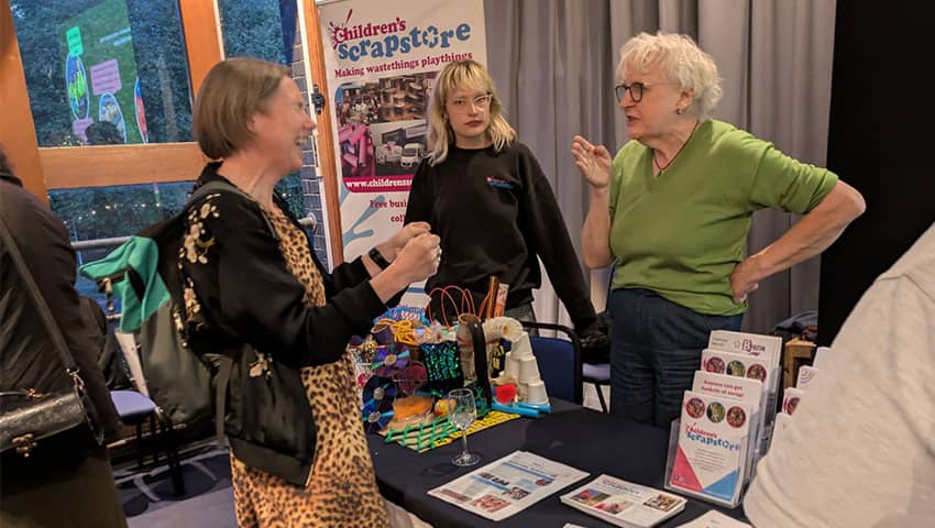 A stall holder talking to a guest after the BDAS Waste to Worth event.