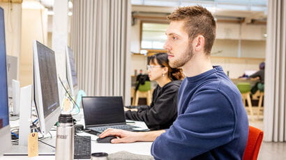 A student using a computer in a study space.