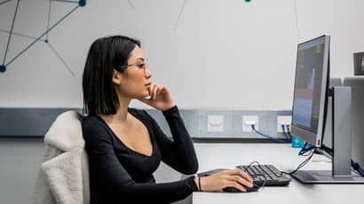 A student using a computer in a study space.