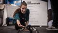 A woman touches a robot at the employers fair