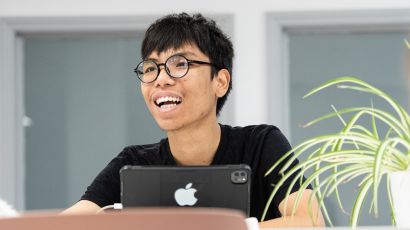 Close up of student speaking while holding a tablet