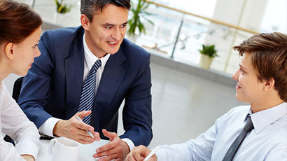 People wearing formal business attire and discussing