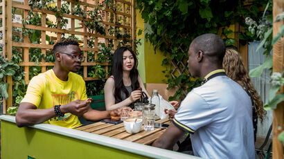 Students sitting in a café and talking.