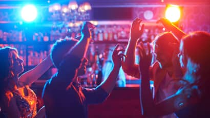 A group of people dancing in a nightclub.