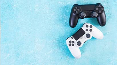 Two game consoles, one is white and the other is black in a blue background.