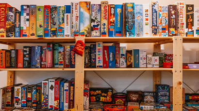 A shelf filled with hundreds of different board games.