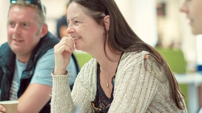 Student smiling, attending workshop