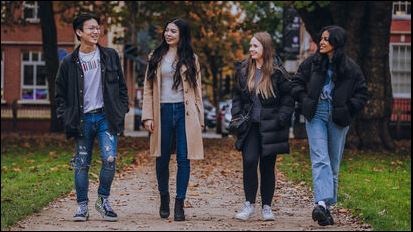 Students walking through a Bristol park.