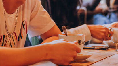Students drinking coffee in a coffee shop.