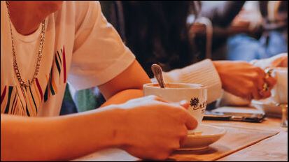 Students drinking coffee in a coffee shop. 