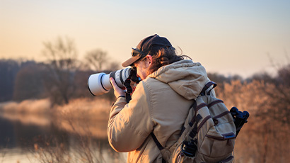 A person taking photos in the wild.