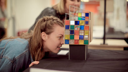 A girl takes a look at some of the work at a degree show