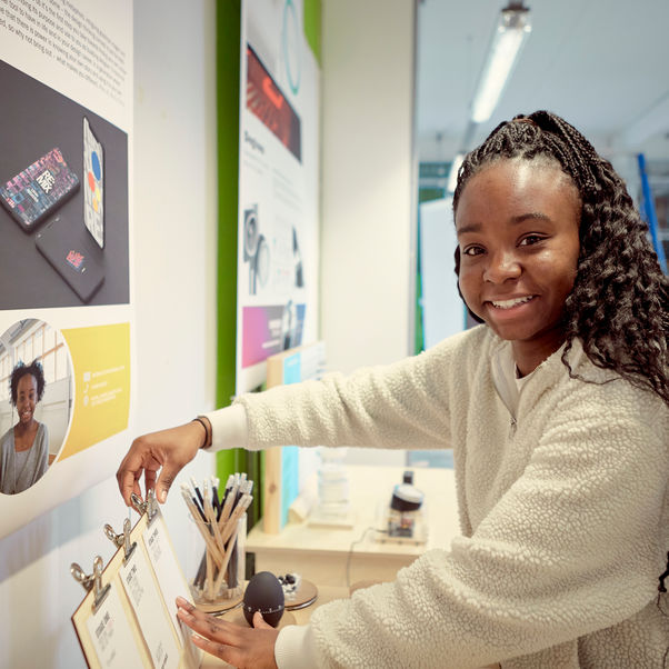 A FET student prepares her exhibition at a degree show