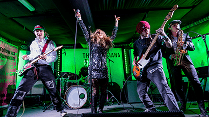 4 members of a band on stage