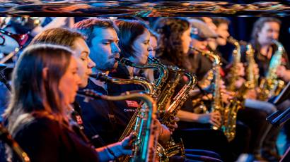 Group of young people playing the saxophone.